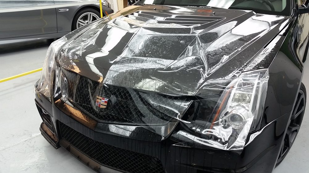 Clear Bra Protection being applied to a car